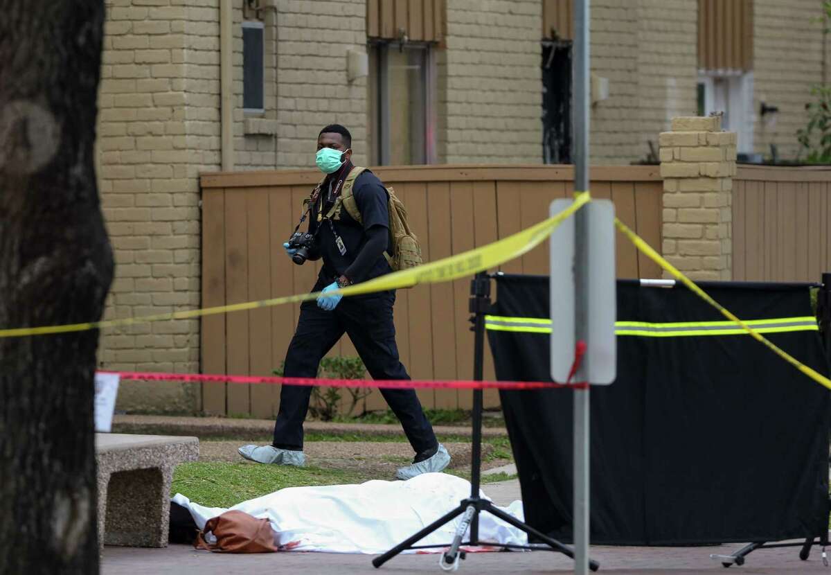 Houston Police Homicide detectives investigate the scene where a woman was fatally stabbed in the chest, at least once, on the 8400 block of Broadway Street Thursday, May 3, 2018, in Houston.