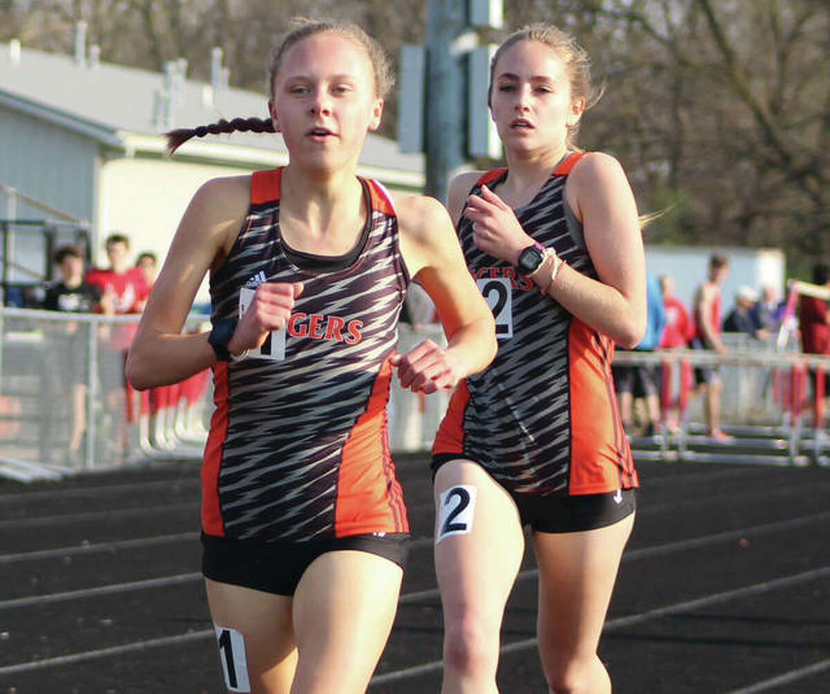 Edwardsville’s Abby Schrobilgen (left) and Hannah Stuart run 1-2 in the 3,200 meters during the Madison County Meet on April 24 in Highland. The Tigers’ juniors repeated the 1-2 finish Wednesday in the 3,200 at the SWC Meet in Collinsville.