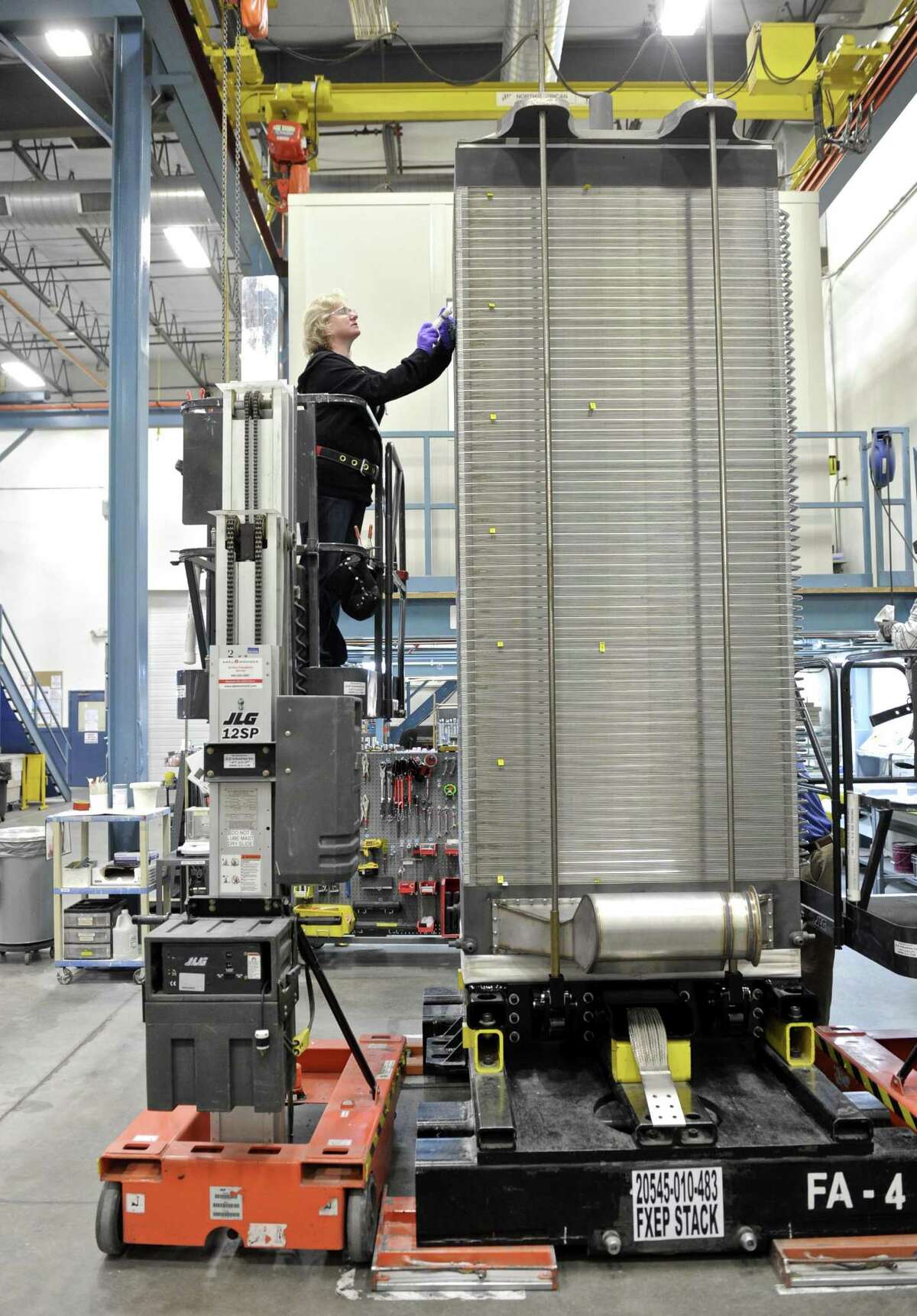 Janet Hixson completes the work on a 400 cell fuel cell stack at the FuelCell Energy manufacturing plant in Torrington, Conn. Wednesday, February 1, 2017.