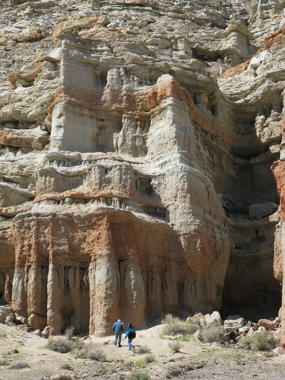 Hikers stand at the base of surreal cliffs in Red Rock Canyon State Park, about 80 miles east of Bakersfield.
