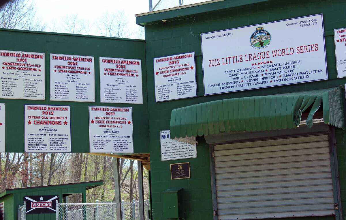 Signs tout the accomplishments of Fairfield American Little League at the entrance to the ballfield at Mill Hill School.