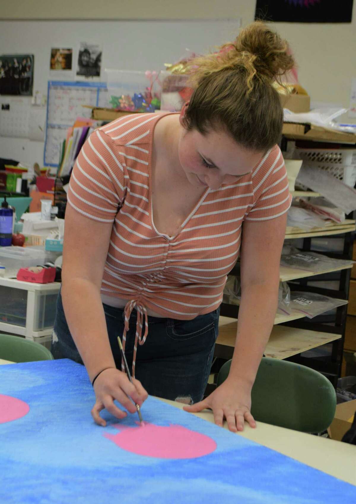 Senior Miranda Calhoun works on her ceiling tile art at Wamogo Regional High School.