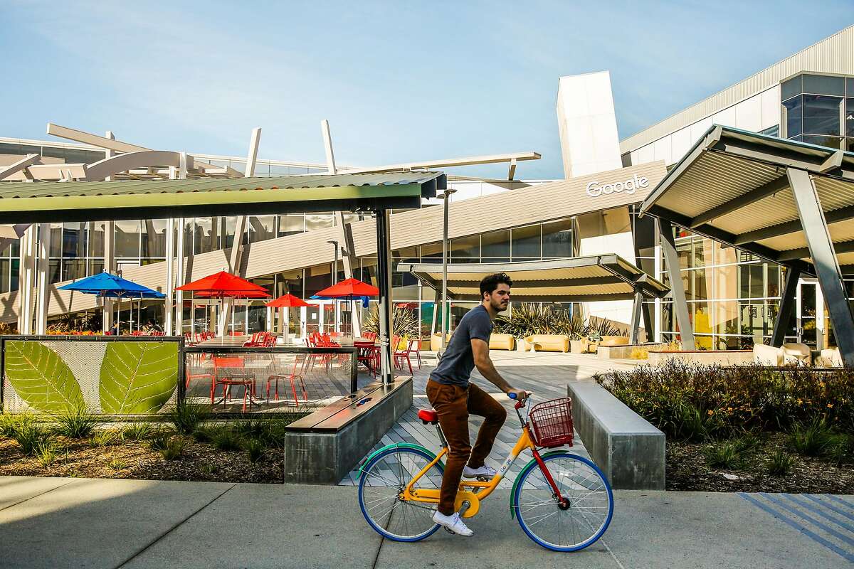 A biker rides through the Google campus in Mountain View, Calif., on Monday, Nov. 27, 2017.