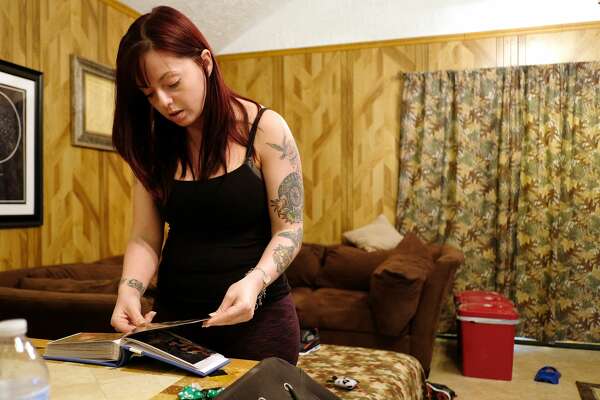 Roseanna McLaren looks through photo albums in her home, in Alvin. Roseanna McLaren's mother, Muta Melton, died in 2015 following a heart transplant at Baylor St. Luke's Medical Center.