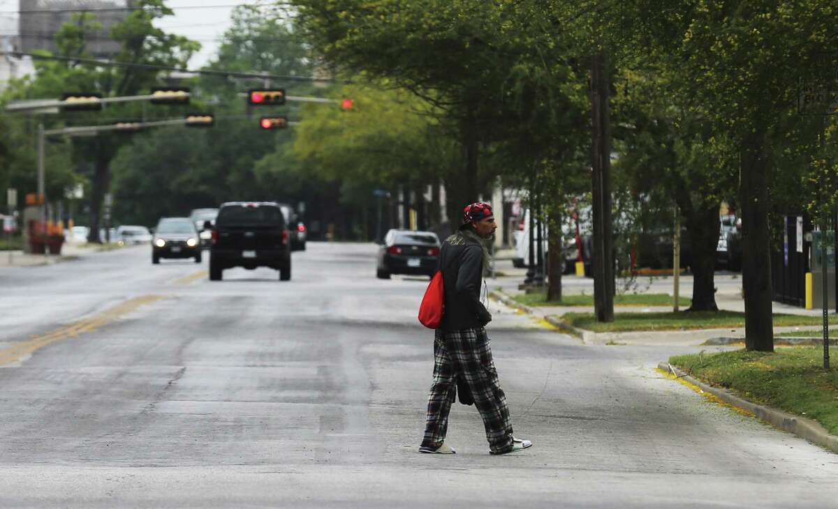 A man walks across McCullough Avenue toward Christian Assistance Ministries in downtown San Antonio on May 3, 2018. In addition to providing food and clothing, CAM gives people who are homeless a place for spiritual help.