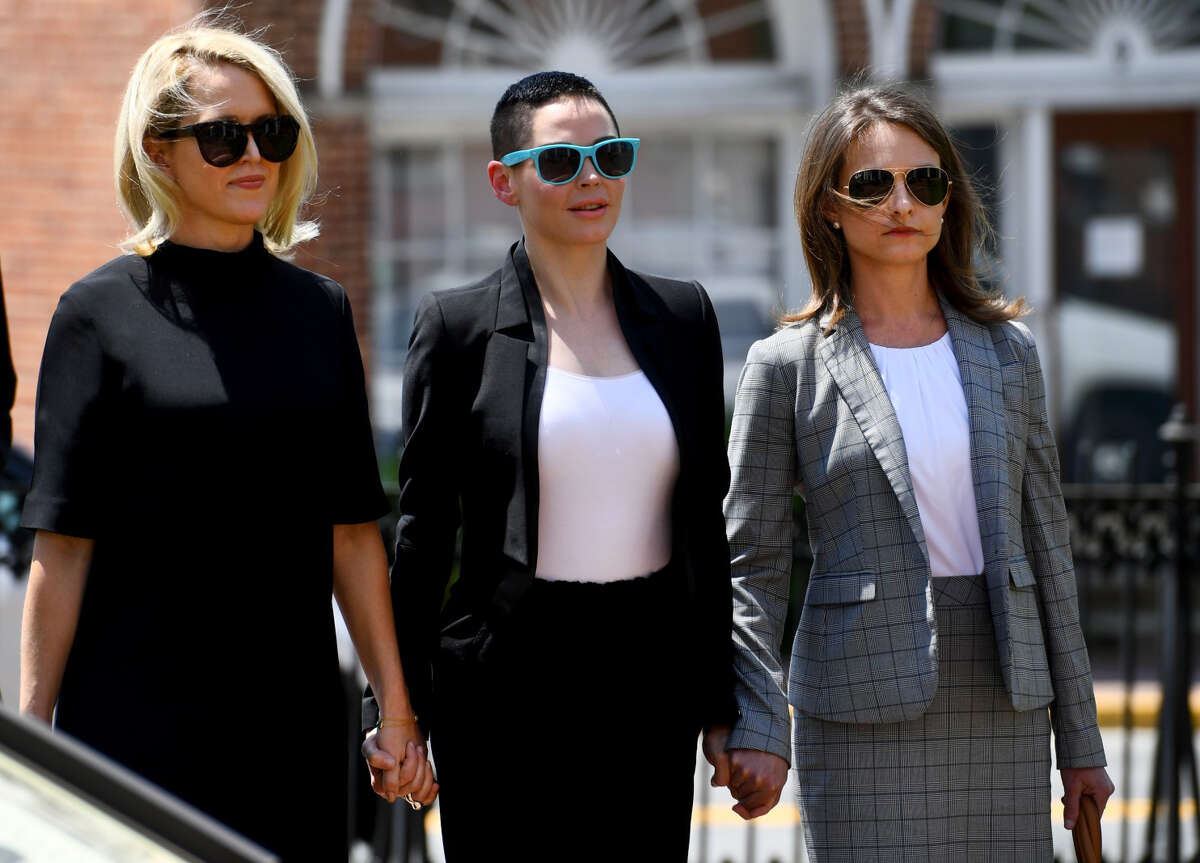 Rose McGowan, center, appears at Loudoun County District Court in Leesburg, Va., for a preliminary hearing on possession of a controlled substance after cocaine was found in the wallet she left on an airplane at Dulles International Airport last year. On the right is her attorney, Jessica Carmichael.