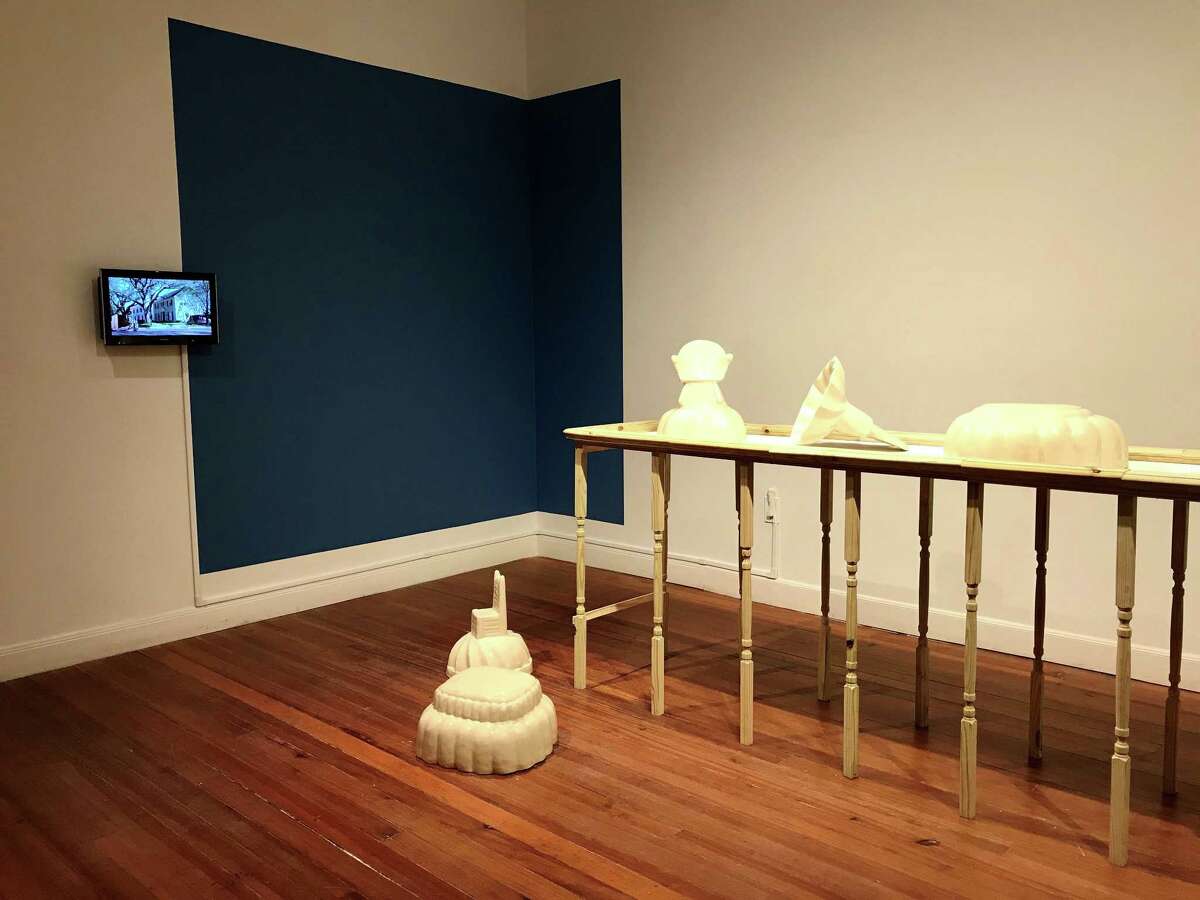 Maria Bang Espersen’s “As American as Apple Pie” installation on the third floor of Lawndale Art Center features a series of ceramics inspired by Jello molds and two videos on small monitors that have inset imagery within passing cars.