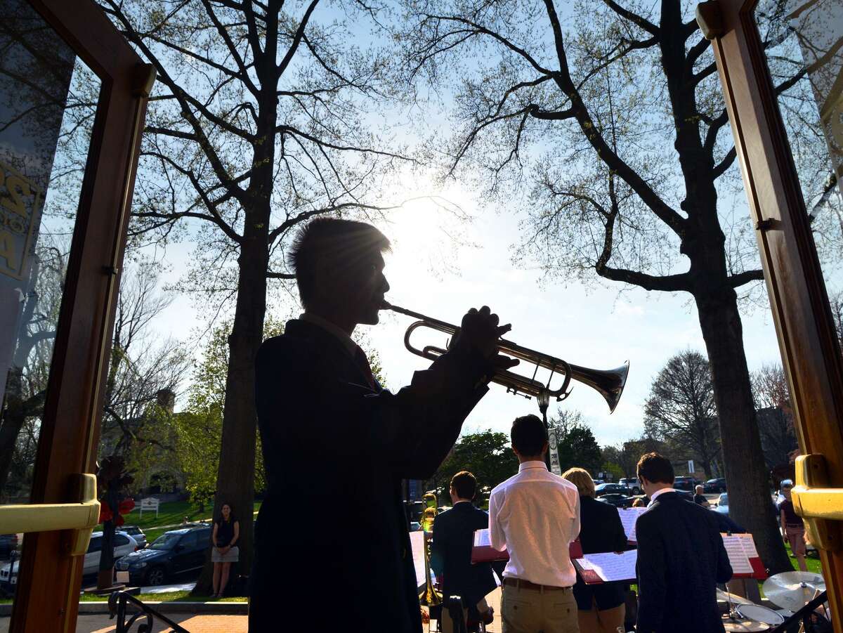 Greenwich High School freshman Artemis Shung, 14, warms up on his trumpet before playing with the GHS Jazz Band during the opening night of Art to the Avenue, the Greenwich Arts Council’s spring art celebration on Greenwich Avenue Thursday.