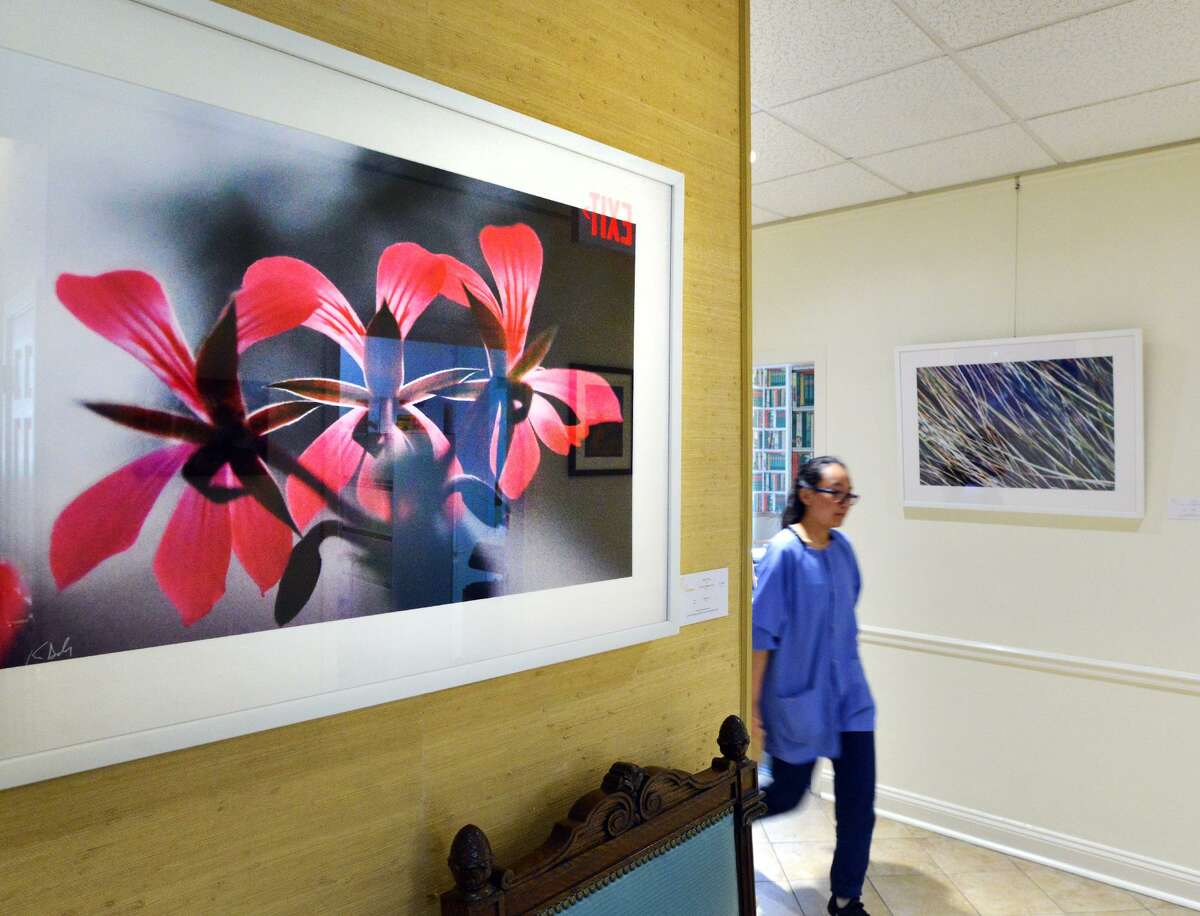 A pigment print by former Greenwich Time staff photographer Keelin Daly titled "Flowers," was on display at The Mews during the opening night of Art to the Avenue, the Greenwich Arts Council's spring art celebration on Greenwich Avenue, Conn., Thursday, May 3, 2018. The arts event features the talent of 105 regional artists with eighty-five merchants participating as show places for the art throughout downtown Greenwich. The art will be shown in those stores until through Memorial Day.