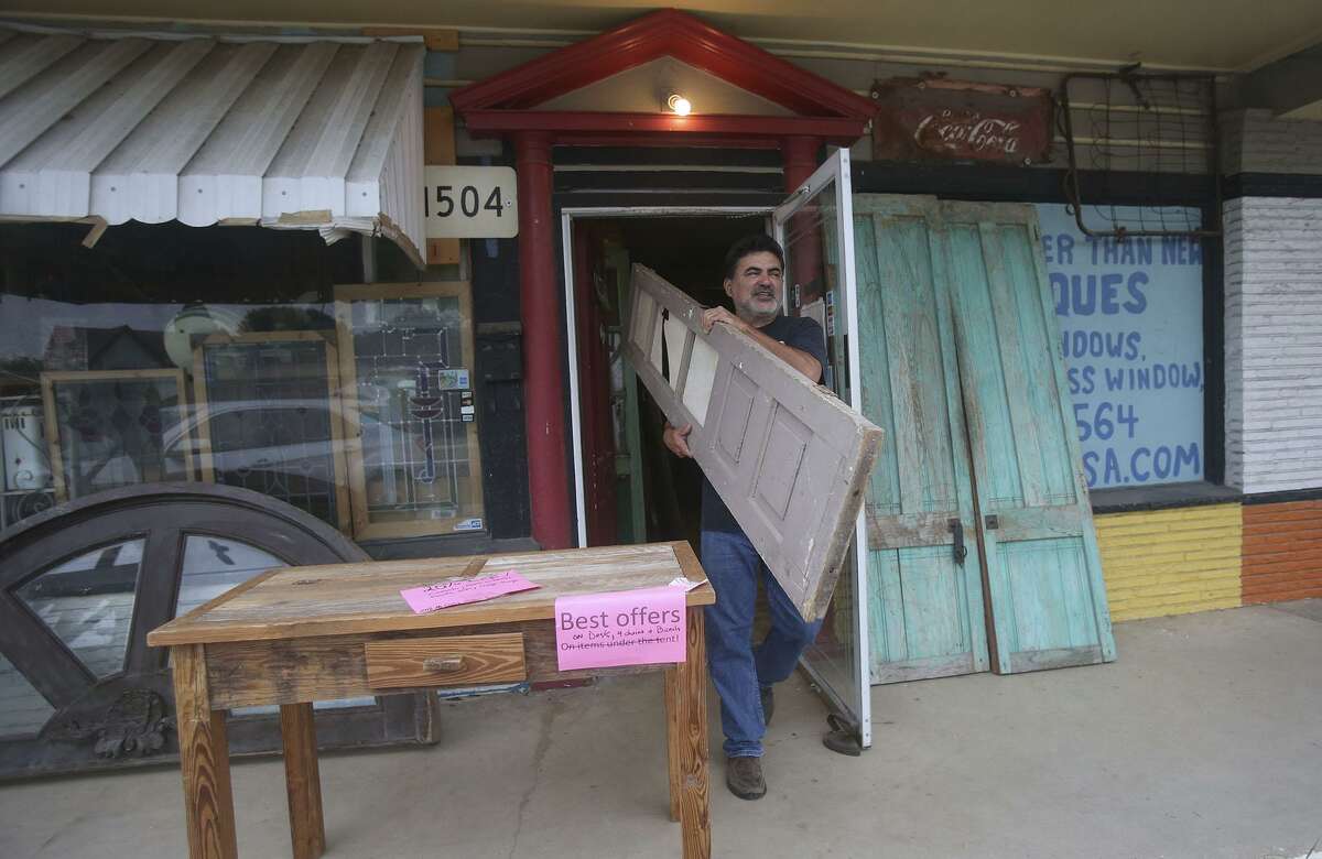 Old is Better Than New store owner Gabriel Galindo carries out some of his merchandise. Galindo specializes in salvaged architectural pieces that usually come from houses that are being torn down.