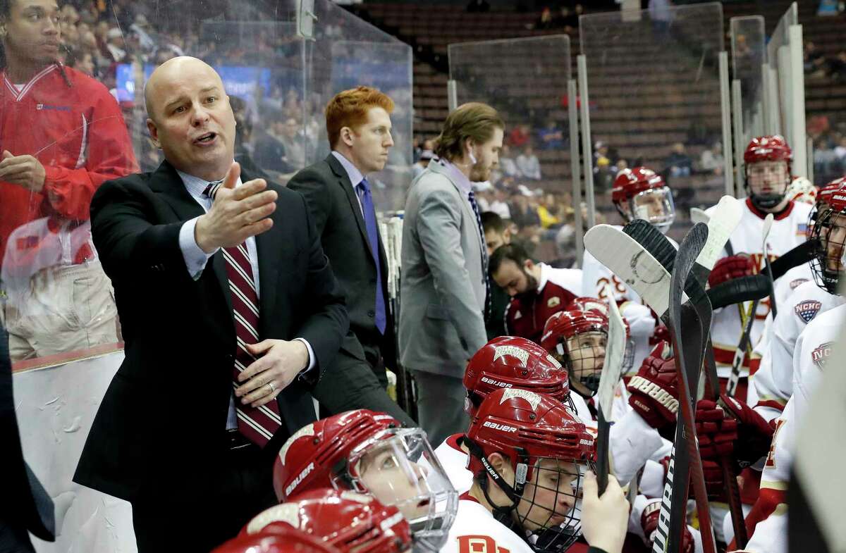 FILE - In this March 25, 2017, file photo, Denver head coach Jim Montgomery, left, directs his players during the first period in the regional semifinals of the NCAA college hockey tournament against Michigan Tech in Cincinnati. A person with knowledge of the situation tells The Associated Press that the Dallas Stars will hire Montgomery to be their next head coach. Montgomery takes over Ken Hitchcock, who retired last month and will become a consultant for the Stars. The person spoke on condition of anonymity Wednesday, May 2, 2018, because the hiring had not been announced. (AP Photo/John Minchillo, File)
