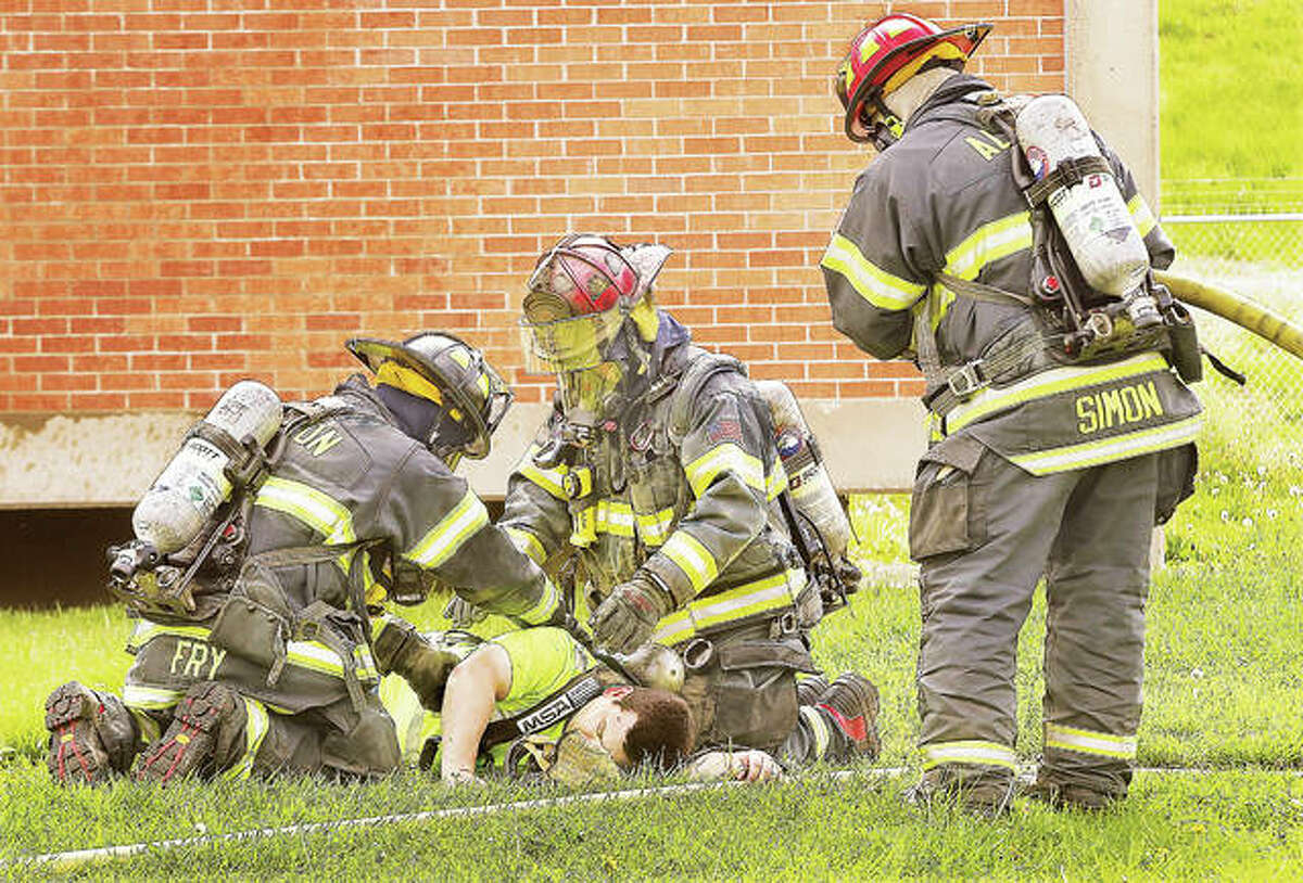 Alton firefighters were called to a drill Wednesday for a mock chlorine leak at the Alton Sewage Treatment Plant at 19 Chessen Lane in Alton. Here, firefighters prepare one of the workers pulled from the mock incident for decontamination with a hose.