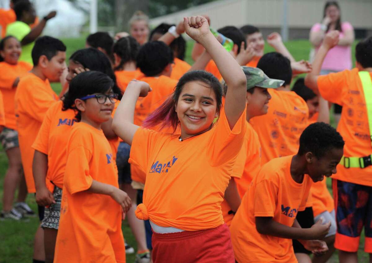 Marvin Elementary School 5th grader Valentina Velasquez warms up with Zumba before the school's walk-a-thon Friday, May 4, 2018, down Beach Road and around Shady Beach in Norwalk, Conn. The school had a fundraising goal of $10,000 and are just under $15,000 raised to date.