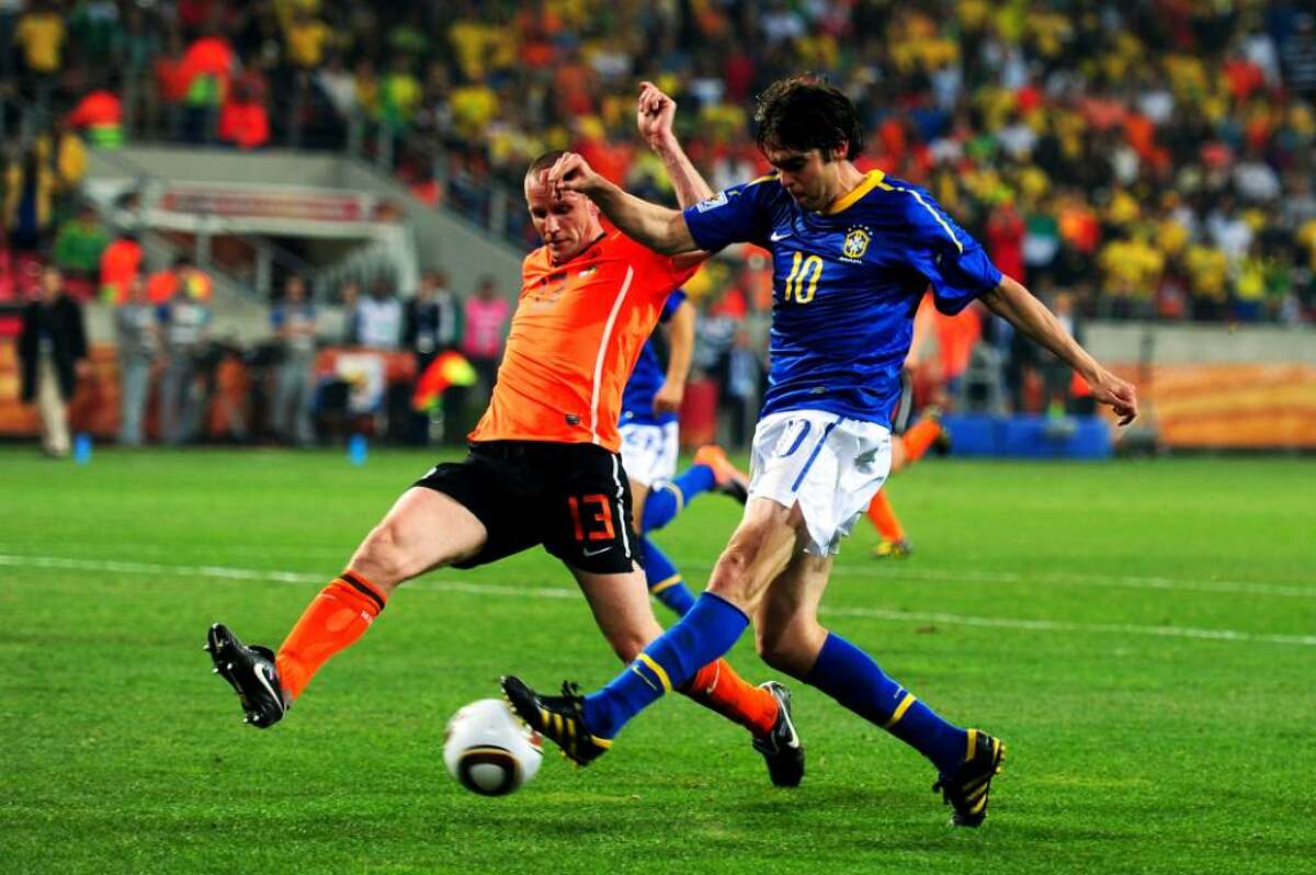 PORT ELIZABETH, SOUTH AFRICA - JULY 02: Andre Ooijer of the Netherlands challenges Kaka of Brazil during the 2010 FIFA World Cup South Africa Quarter Final match between Netherlands and Brazil at Nelson Mandela Bay Stadium on July 2, 2010 in Nelson Mandela Bay/Port Elizabeth, South Africa. (Photo by Laurence Griffiths/Getty Images) *** Local Caption *** Andre Ooijer;Kaka