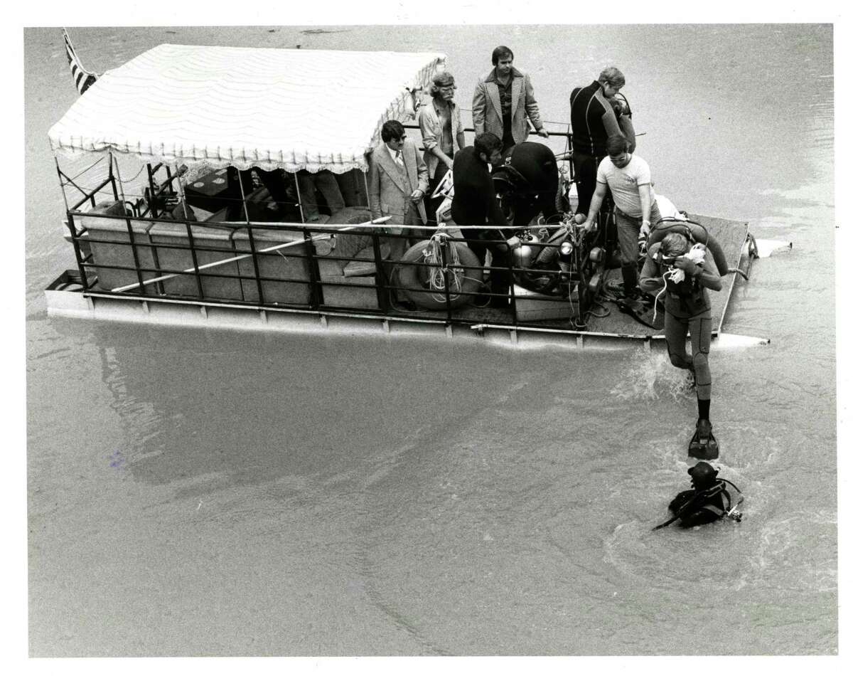 05/11/1977 - Divers search Buffalo Bayou site where Joe Campos Torres body was found floating May 8, 1977. The location is just off the 1200 block of Commerce. Divers were hoping to find a wallet belonging to Torres.