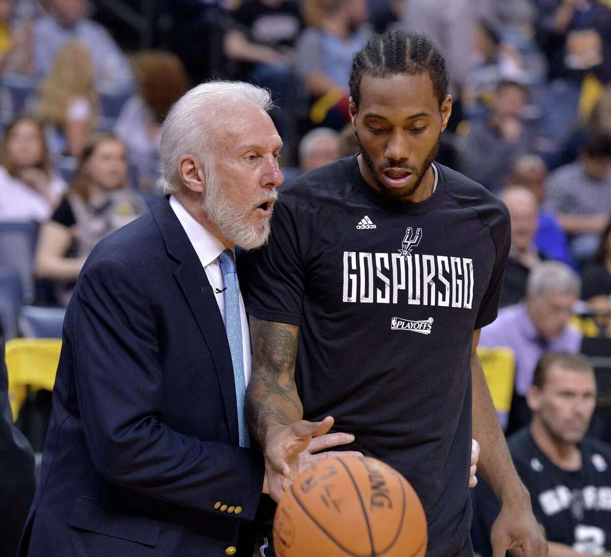 FILE - In this April 22, 2017, file photo, San Antonio Spurs head coach Gregg Popovich, left, talks with San Antonio Spurs forward Kawhi Leonard during the second half of Game 4 in an NBA basketball first-round playoff series against the Memphis Grizzlies, in Memphis, Tenn. The absolute unwillingness to answer certain questions is part of the San Antonio Spurs' mystique. The Spurs just don't share much. So there is some unmistakable irony here that when it comes to the obviously fractured relationship between San Antonio and Kawhi Leonard, it's the Spurs who are the ones frustrated by the lack of answers.(AP Photo/Brandon Dill, File)