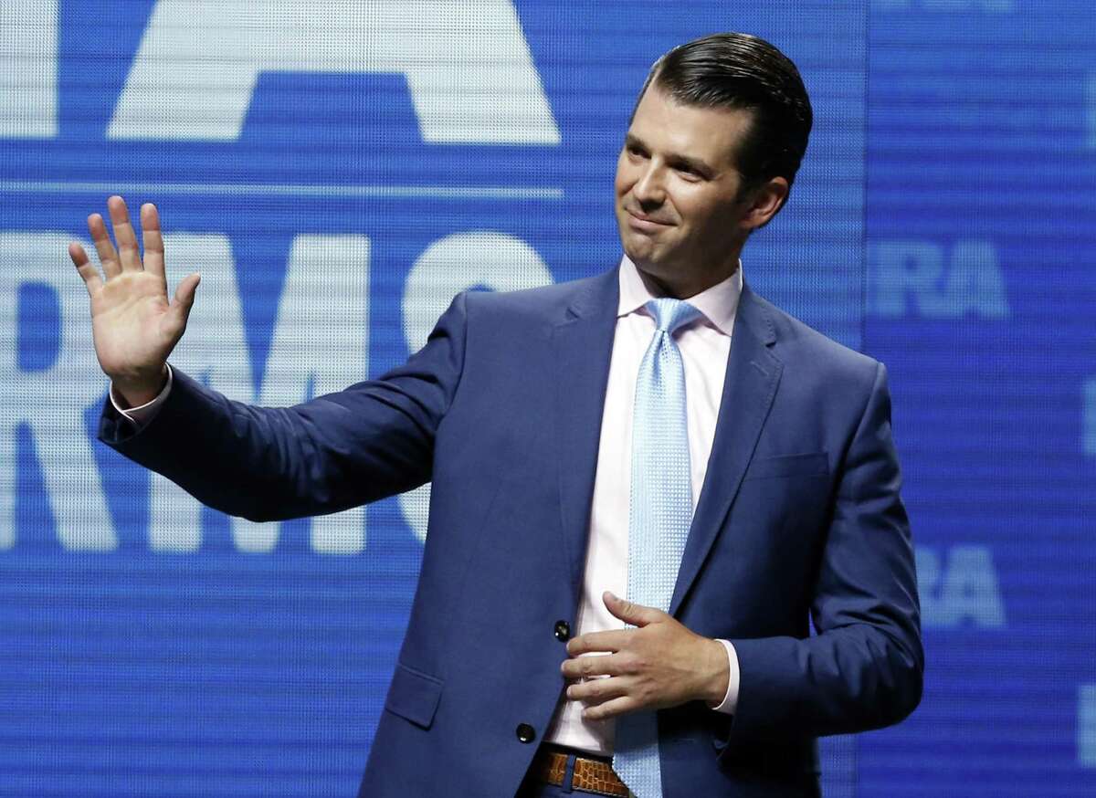 Donald Trump Jr., waves from the stage Friday at the National Rifle Association-Institute for Legislative Action Leadership Forum in Dallas.