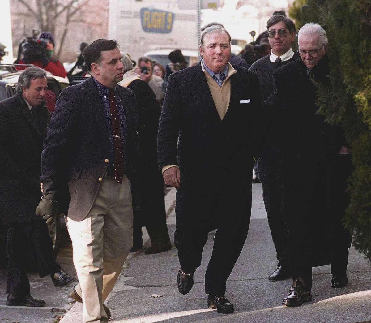 Michael Skakel, center, is led into Greenwich police headquarters by Frank Garr, right, where he was arrested and processed for the murder of Martha Moxley which occured on Oct 30th, 1975. Garr was the lead Greenwich police investigator on the case. At the far left is Skakel's lawyer, Mickey Sherman.