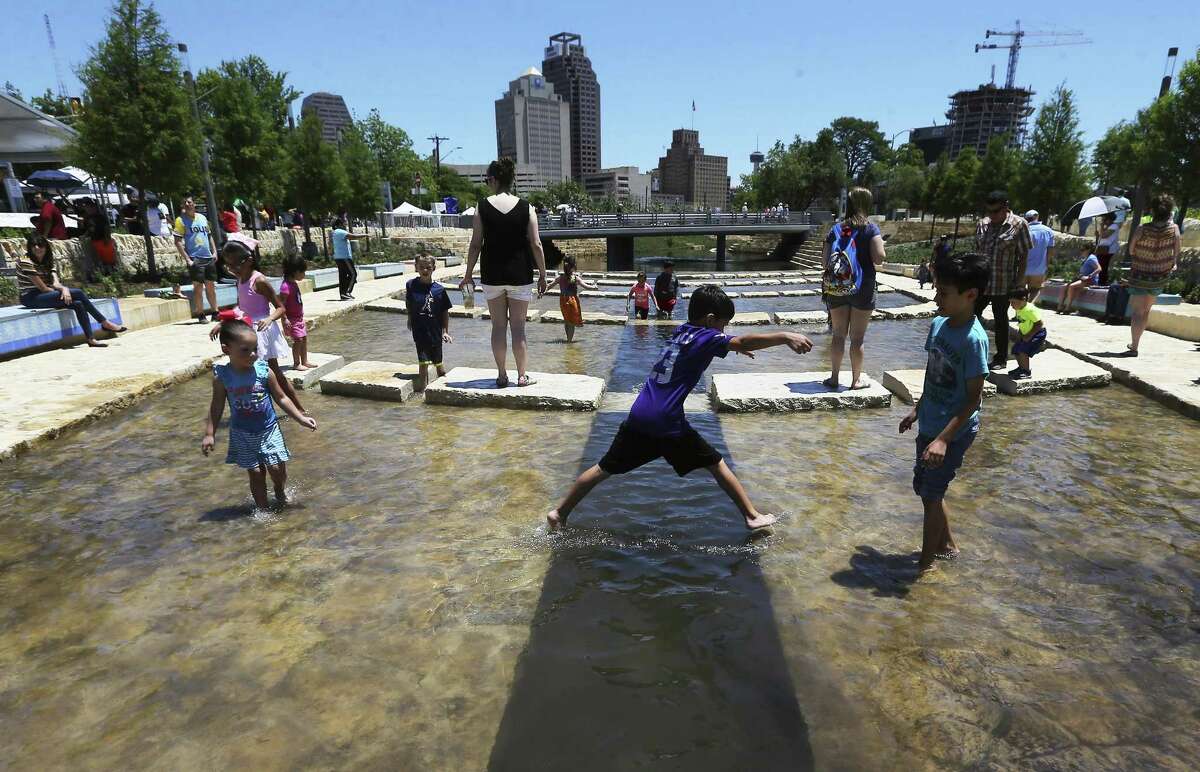 Children play in the water at the grand opening Saturday of San Pedro Creek and its new linear park called San Pedro Creek Culture Park. The event included music, children’s activities and historical presentations, as well as an evening Illumination ceremony.