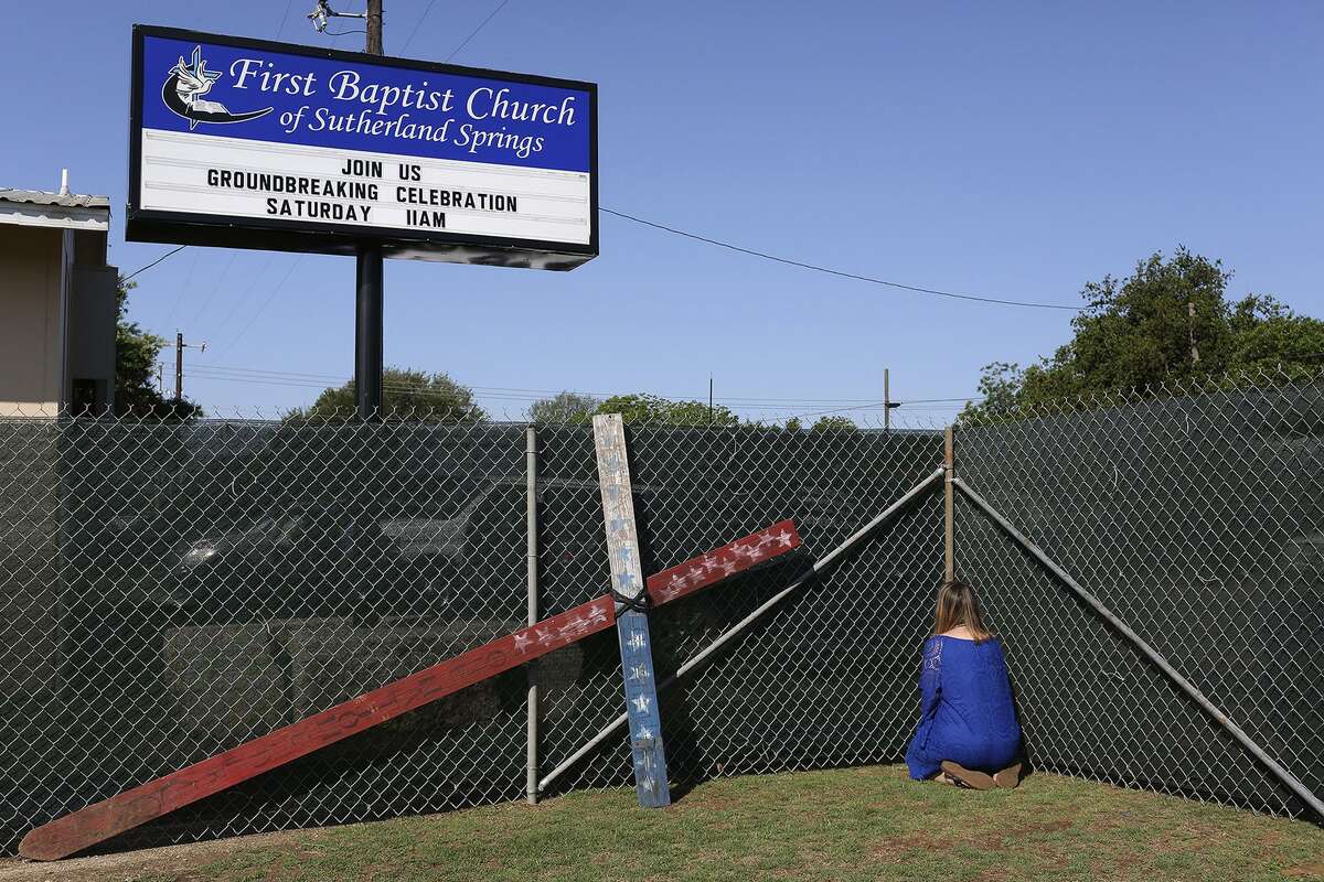 Sherri Pomeroy prays, along with many others, along the fence perimiter where Karla Holcombe prayer walked for years asking God to give the land to the church. Sherri paused to kneel in prayer at every corner, the boundries of the land now owned by the church, during the prayer walk which was part of First Baptist Church of Sutherland Springs' Groundbreaking Celebration on Saturday, May 5, 2018. Holcombe lost eight family members in the mass shooting at the church.