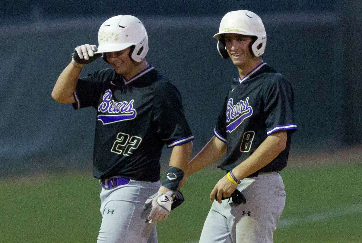 Montgomery's Jacob Prigmore (22) shares a laugh with Jordan Hood (8) after his 2-RBI single gave the Bears a 5-4 lead during the seventh inning of a District 12-6A high school baseball game, Tuesday, April 24, 2018.