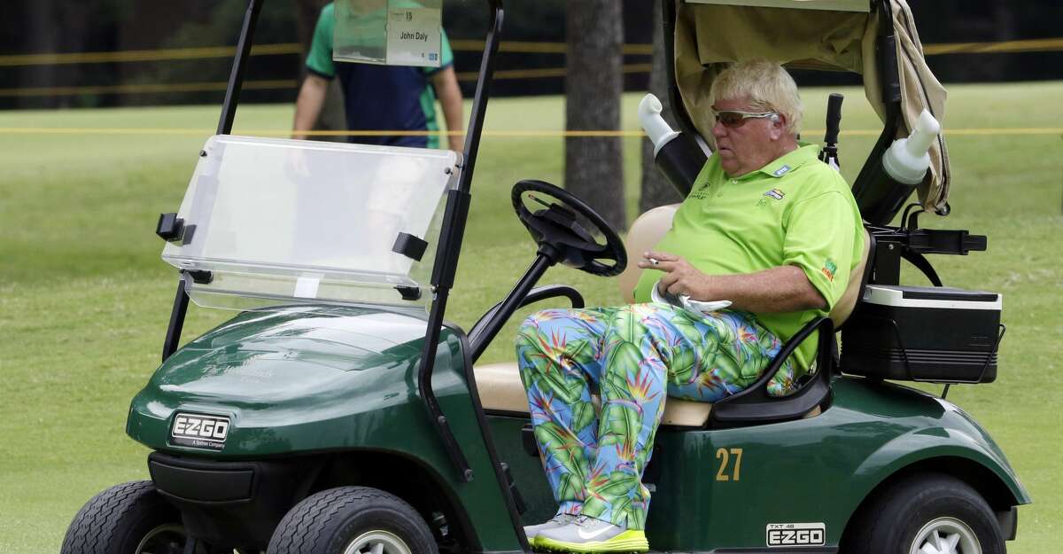 John Daly takes a smoke break in a cart on the 6th green during the first round of the Insperity Invitational at the The Woodlands Country Club Friday, May 4, 2018, in The Woodlands, TX. (Michael Wyke / For the Chronicle)