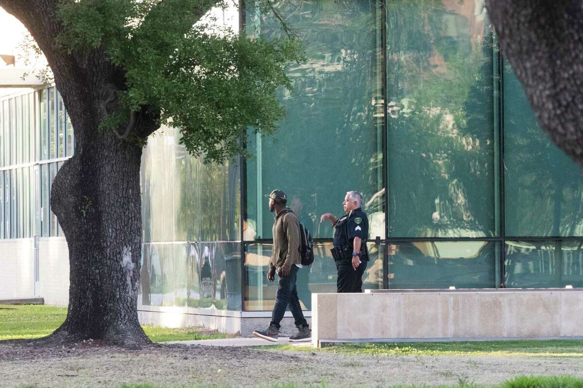 A police officer explains to Spencer Swearingen that HCC Holman campus has shut down after a threat was published on social media on Sunday. Monday, May 7, 2018, in Houston.