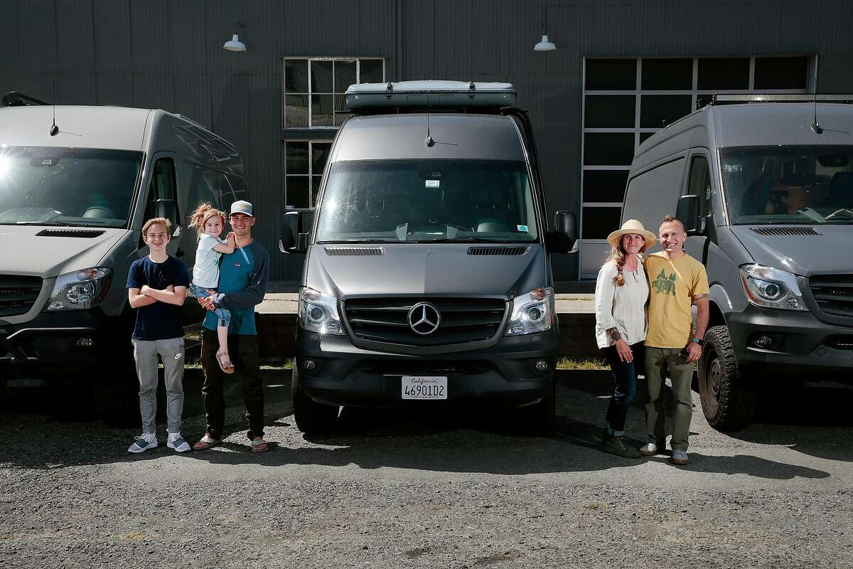 Jen and Cemil Hope, with three of their four children, Christopher, 12, Amelie, 5, and Bodhi, 19, pose for a portrait with three Mercedes-Benz Sprinter cargo vans in Petaluma.