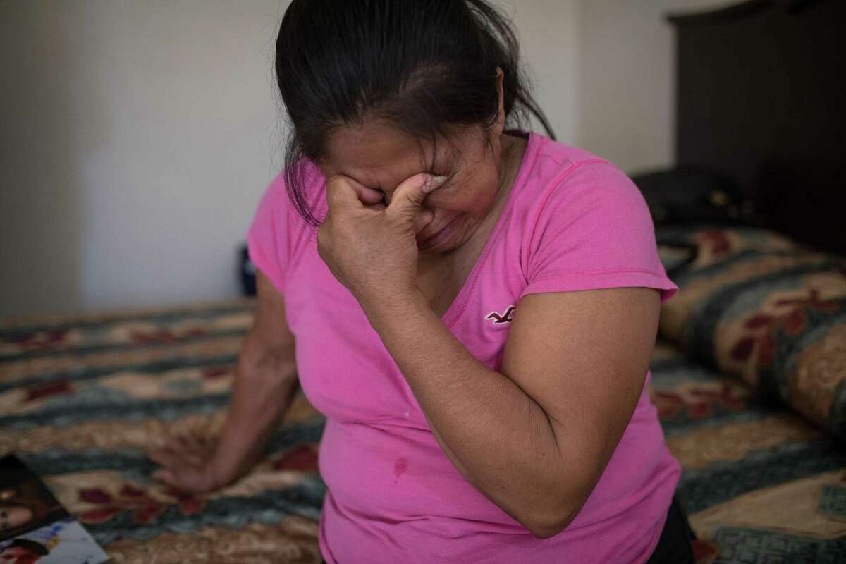 Martha Olmedo, who lost five children and two grandchildren during the drug war, is overcome with emotion while looking at images of her family at her hotel in Miguel Alemn in Tamaulipas, Mexico on May 2, 2018. (Tamir Kalifa for The San Antonio Express-News)