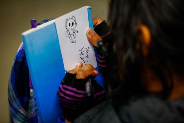 Jessica Vasquez Aguilar, 14, doodles on a piece of paper during an exercise at Camp Everytown.