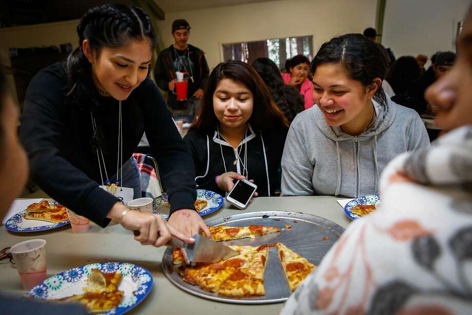 (l-r) Gladis Becerra, 15, Sherly Morales,14 and Ana Fifita,14 eat pizza for lunch on the last day of camp in Santa Cruz, California, on Saturday, Oct. 14, 2017. Photo: Gabrielle Lurie / The Chronicle