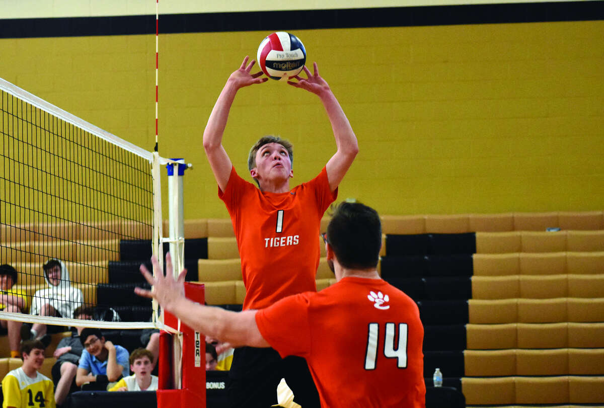 Edwardsville setter Lucas Verdun sets the ball for middle hitter Drew Berthlett (No. 14) during the first game against Vianney on Monday in St. Louis. The Tigers lost in three games.