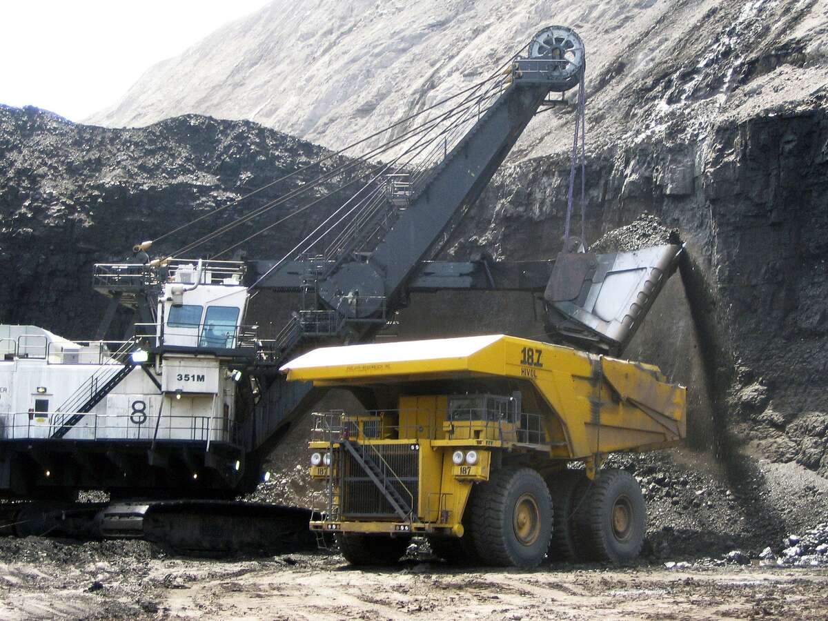 FILE - In this April 30, 2007, file photo, a shovel prepares to dump a load of coal into a 320-ton truck at the Arch Coal Inc.-owned Black Thunder mine in Wright, Wyo. Six of the country's major energy-producing states have slipped into recession after a sharp decline in production and exploration over the last 18 months caused their tax revenue to plummet, according to a financial analysis released Tuesday, Jan. 24, 2017. (AP Photo/Matthew Brown, File)