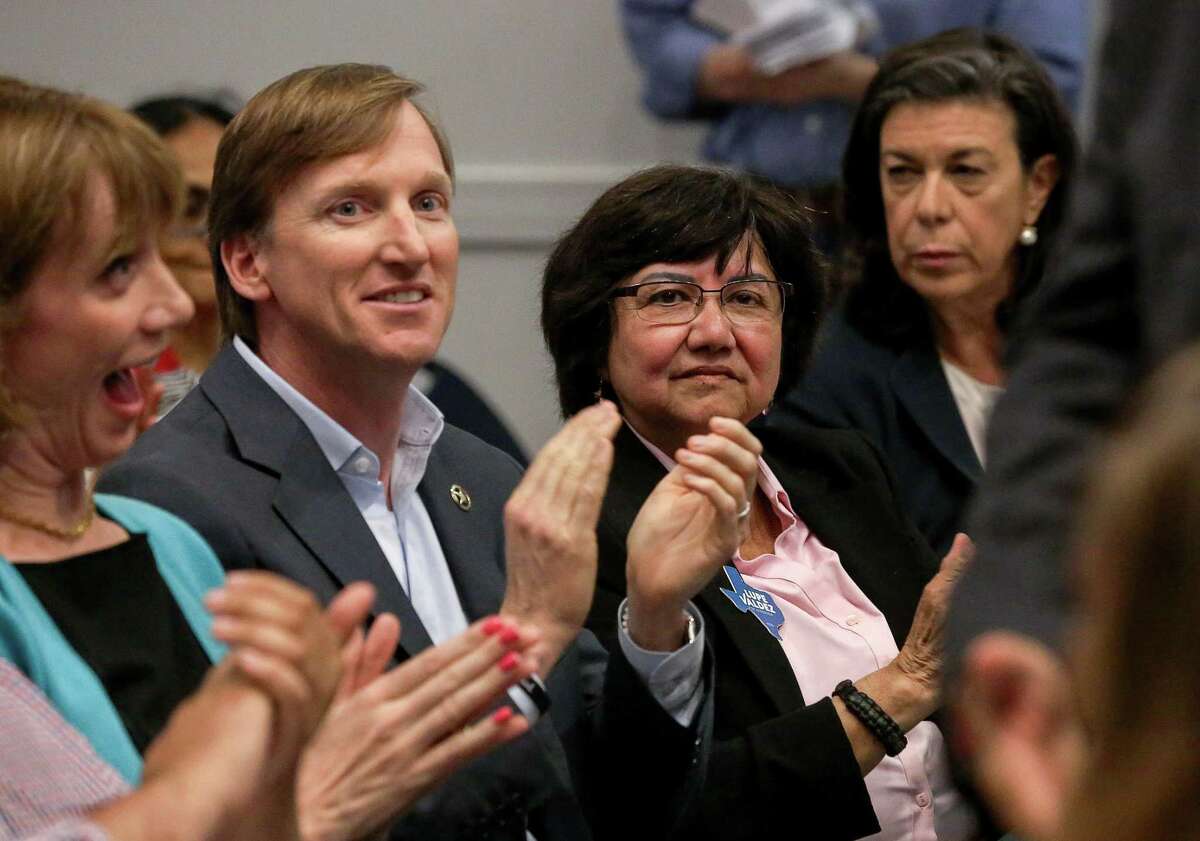 Gubernatorial candidates Andrew White, center-left, and Lupe Valdez, center-right, listen to other speakers at a reception for Democratic run-off candidates April 25 in Houston. White and Valdez have agreed to debate Friday at 7 p.m. at the St. James Episcopal Church in Austin.