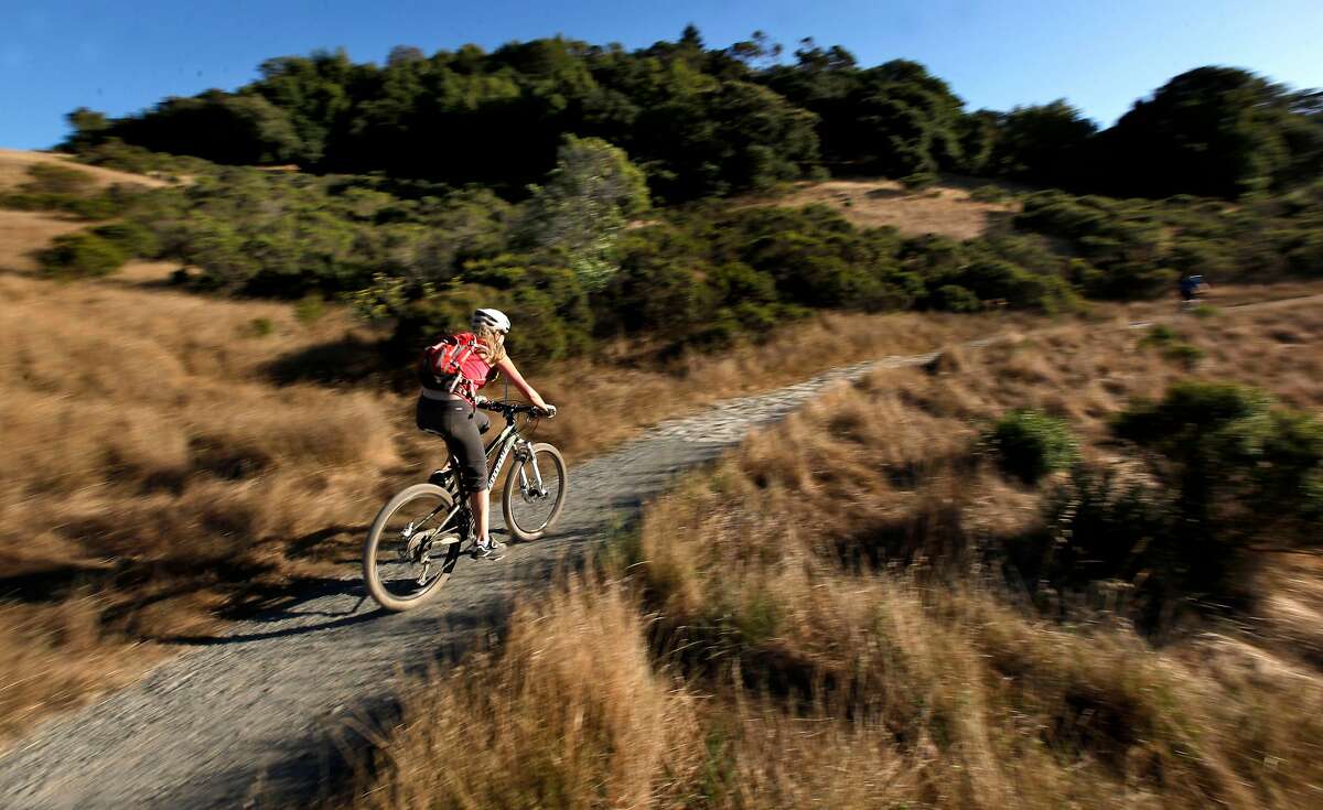 Mountain biker cruises the rolling hills at China Camp State Park, reopened this week with limiting parking and access to trails and beaches