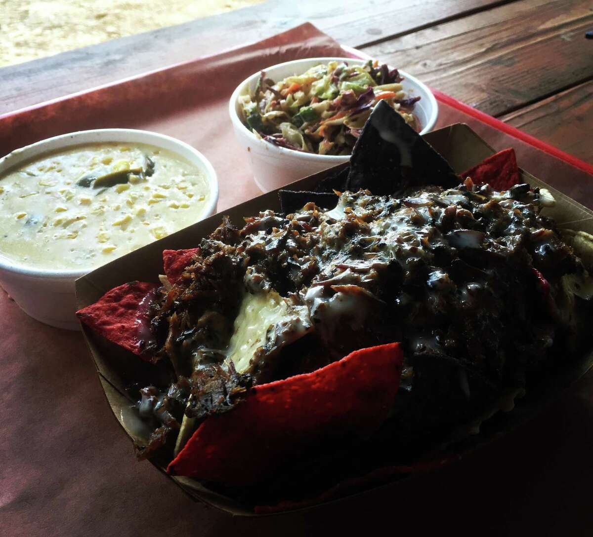 The BBQ nachos ($8) are topped with chopped brisket or pulled pork and layered with a white queso sauce.