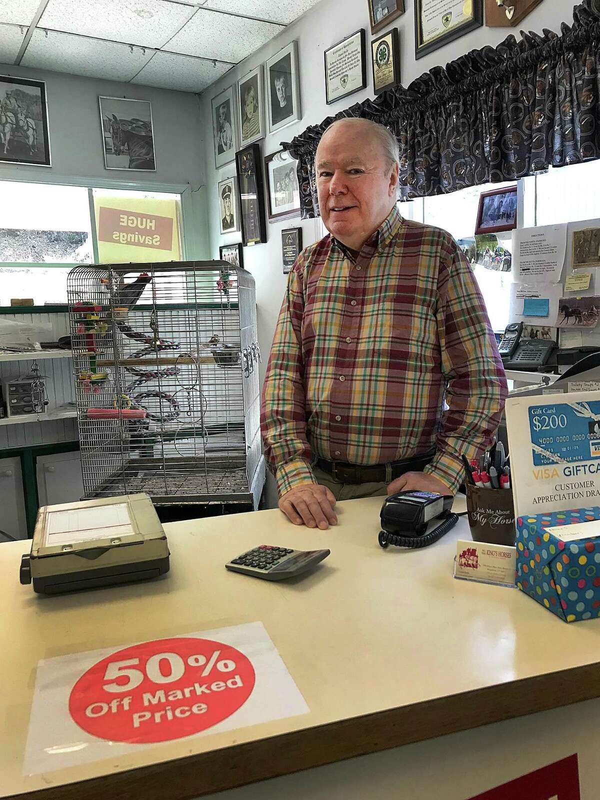 Dan Reilly stands behind the counter at All The Kings's Horses on Ethan Allen Highway in Ridgefield, Conn., on Tuesday, May 8, 2018. Reilly is closing the shop for retirement after 44 years in business.