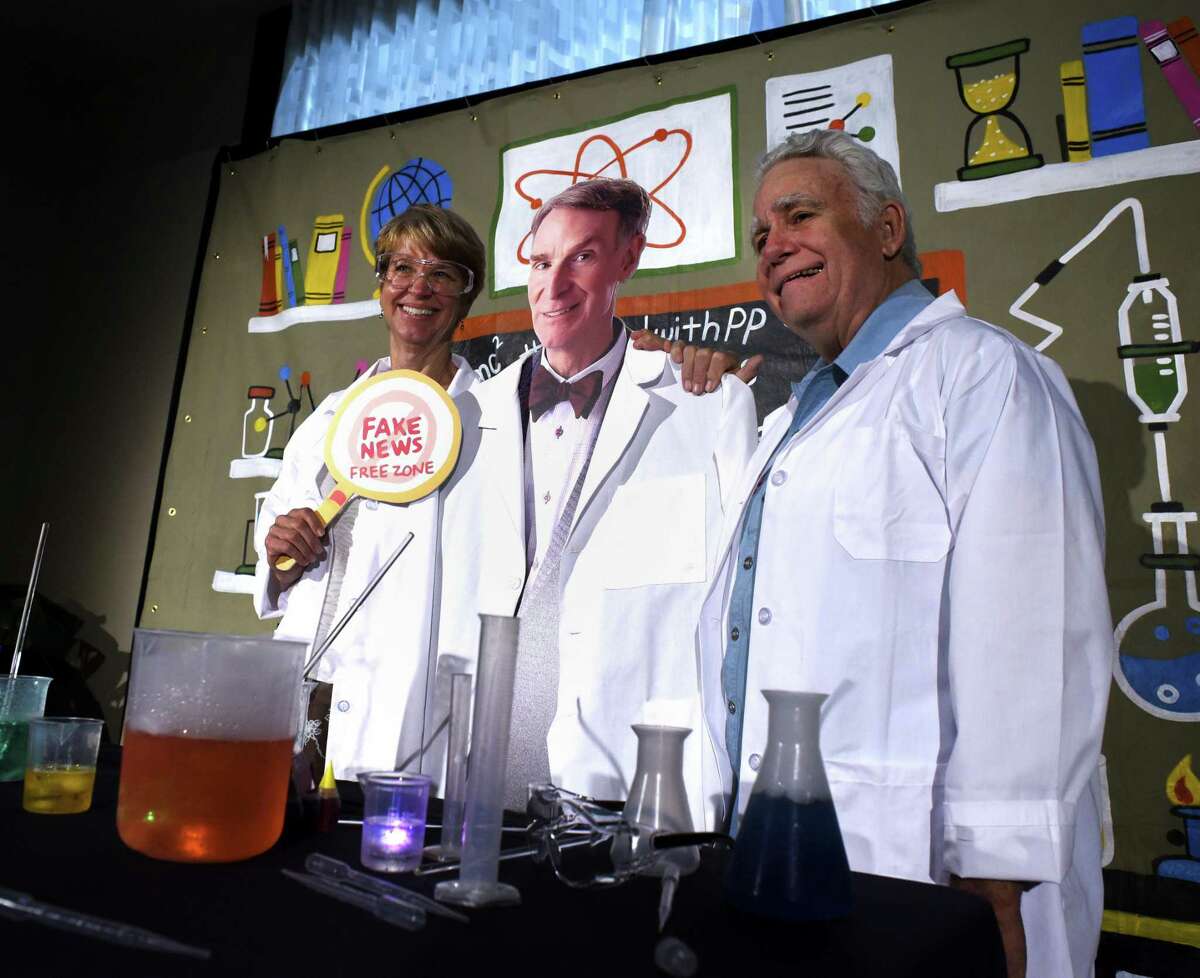 Carolyn Chipman Evans, left, and her husband, Brent Evans, pose for a picture with a cardboard cutout of Bill Nye, popularly known as “the science guy,” before attending the Planned Parenthood South Texas fundraising luncheon Tuesday. Nye was the featured speaker.