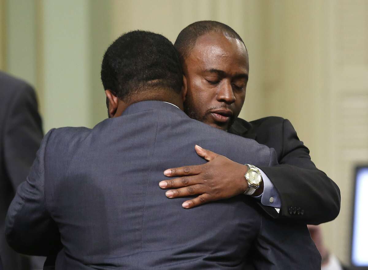 Assemblyman Tony Thurmond, D-Richmond, right, is congratulated by Assembly Sebastian Ridley-Thomas, D-Los Angeles, after his measure requiring all schools, including charters schools, to be tobacco-free, was approved by the Assembly Thursday, March 3, 2016, in Sacramento, Calif. The bill, part of a package of bills aimed at restricting access to tobacco, now goes to the Senate.(AP Photo/Rich Pedroncelli)