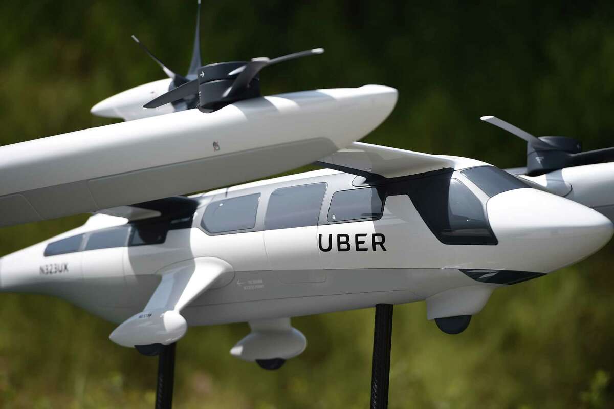 A model of Uber's electric vertical take-off and landing vehicle concept (eVTOL) flying taxi is displayed at the second annual Uber Elevate Summit, on May 8, 2018 at the Skirball Center in Los Angeles, California. Uber introduced it's electric powered "flying taxi" vertical take-off and landing concept aircraft at the event, which showcases prototypes for UberAir's fleet of airborne taxis. / AFP PHOTO / Robyn BeckROBYN BECK/AFP/Getty Images