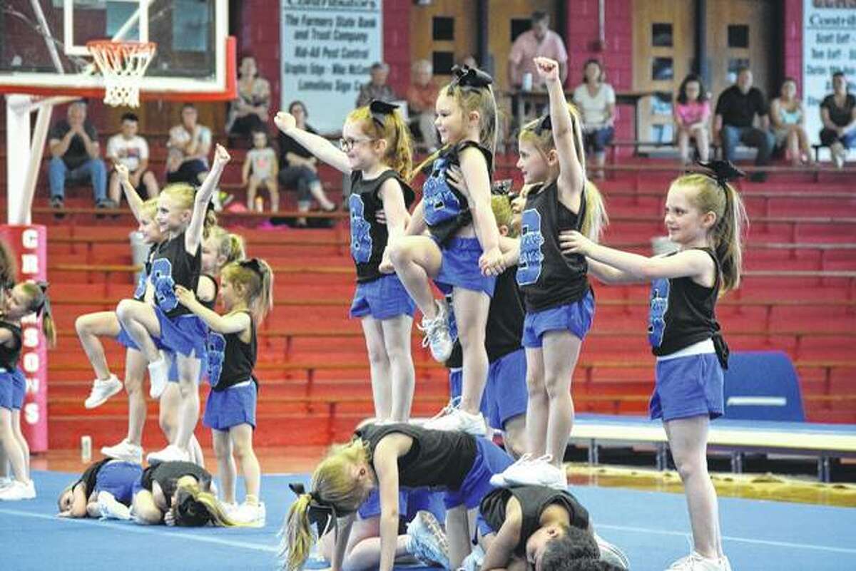 Girls between the ages of 5 and 7 perform a cheer routine Tuesday during the 12th annual Sara’s Studio of Dance Tumbling and Cheer Recital at the Jacksonville High School Bowl.