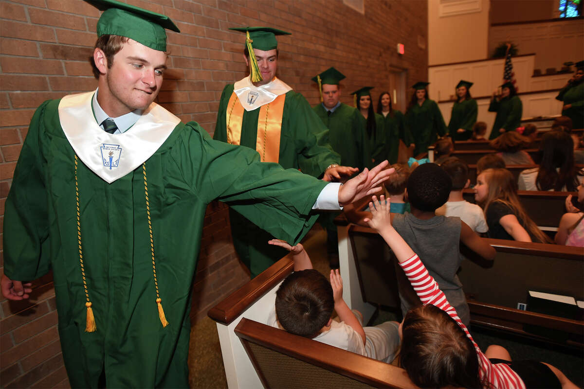 Little Cypress-Mauriceville High School seniors walk through North Orange Baptist Church Monday, May 07 during Senior Walk Day. The event allows the soon-to-be graduates to walk through their alma mater elementary school and encourages the younger children to stay in school. Photo taken Monday, May 07, 2018 Guiseppe Barranco/The Enterprise