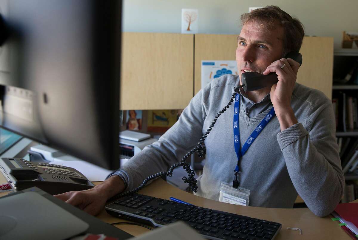 Marin County Public Health Officer Dr. Matthew Willis speaks on the phone while working inside his office Thursday, April 19, 2018 in San Rafael, Calif.