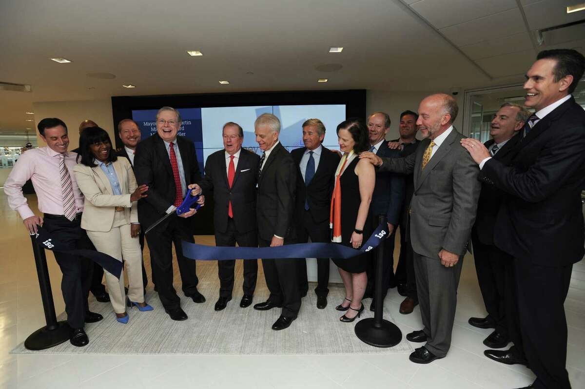 Stamford mayor David Martin (center left) and ISG CEO Michael Connors cut the ceremonial ribbon at the IT consulting and research firm's new offices on Atlantic St. in the Harbor Point area of Stamford, Conn. on Wednesday, May 9, 2018.