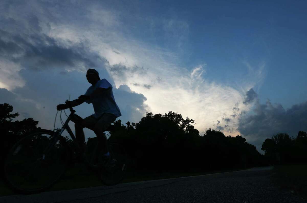 A man rides his bike along the Terry Kershey Hike and Bike Trail at sunset, Tuesday, Sept. 20, in Houston. ( Jon Shapley / Houston Chronicle )