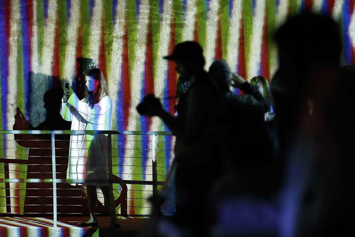People take photos as artist Carlos Cruz-Diez’s site-specific “Spatial Chromointerference” work is previewed at the Buffalo Bayou Park Cistern.