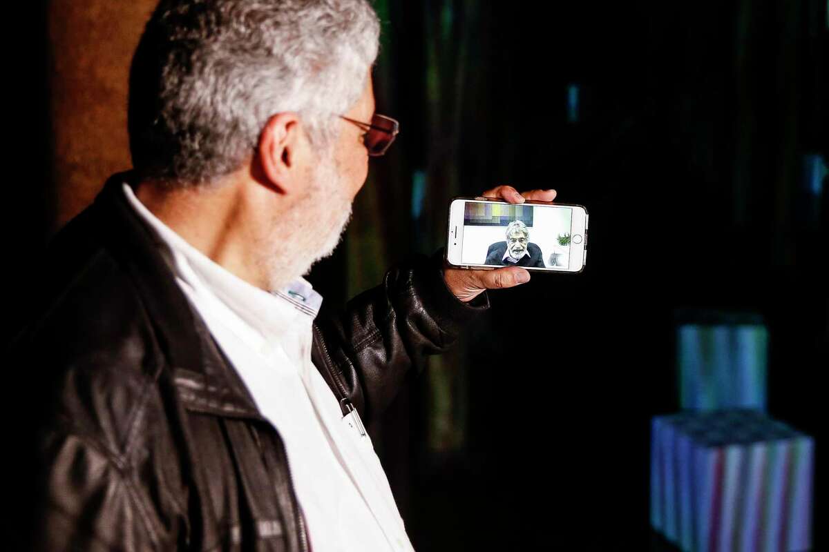 Carlos Cruz-Diez Jr. left, takes his father, artist Carlos Cruz-Diez, on a video call tour of his site specific "Spacial Chromointerference" work at the Buffalo Bayou Park Cistern Wednesday, May 9, 2018 in Houston. (Michael Ciaglo / Houston Chronicle)