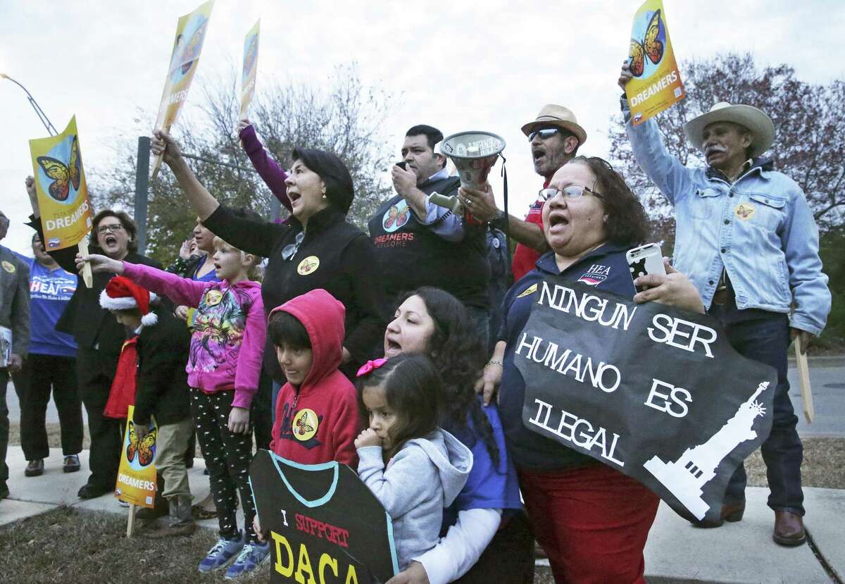 Demonstrators shout out their demand for a clean Dream Act as the president of the Texas State Teachers Association and San Antonio educators rally outside Congressman Will Hurd's office in San Antonio on December 14, 2017.