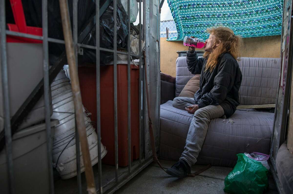 Tiger, a homeless woman, drinks Gatorade inside her structured shack at their encampment near Pennsylvania Avenue and Cesar Chavez Wednesday, May 9, 2018 in San Francisco, Calif.