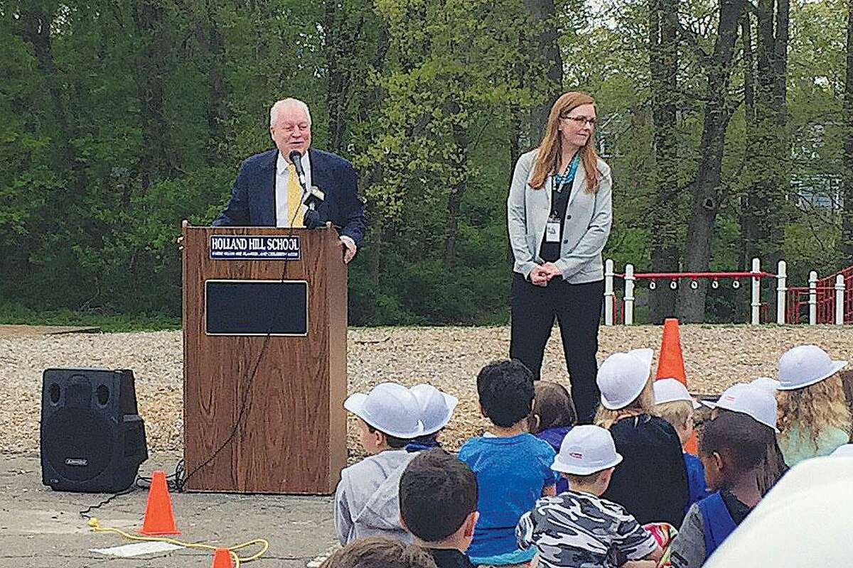 First Selectman Mike Tetreau speaks as Principal Molly Farrell looks out at students at the groundbreaking of Holland Hill Elementary School on Thursday, May 10, 2018.